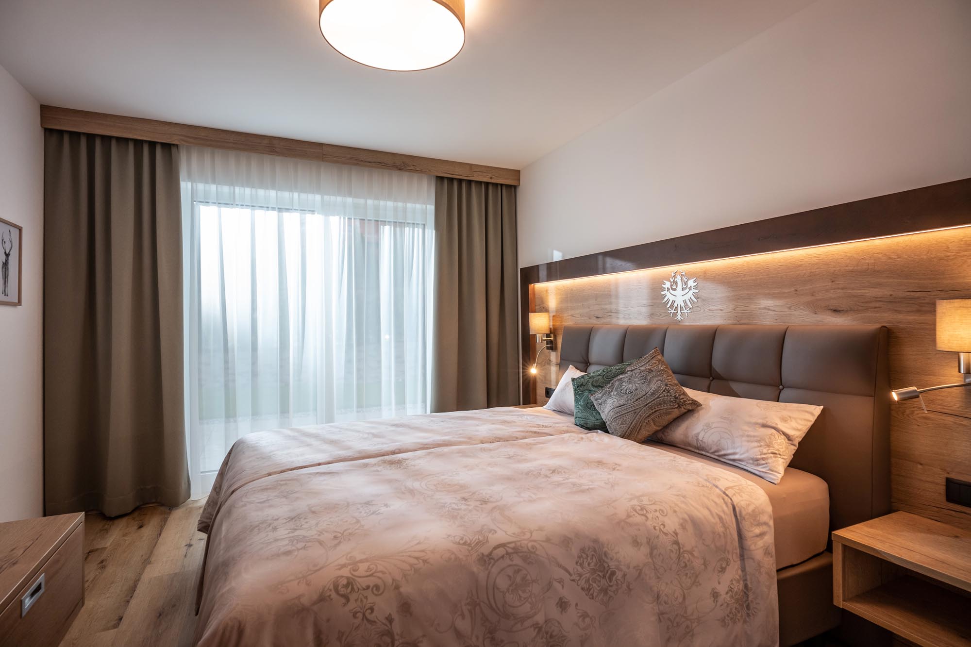 Bedroom including a box spring bed and a flat screen TV