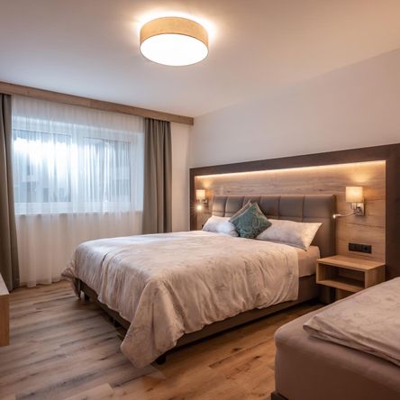 Schlafzimmer für 3 Gäste im APART deluxe Söll in Tirol